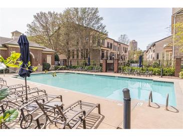 Resort-style community pool with lounge chairs and manicured landscaping in a luxurious neighborhood at 3635 E Paces Ne Cir # 1209, Atlanta, GA 30326