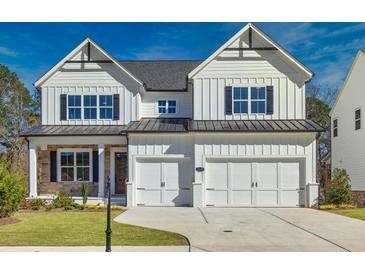 Charming two-story home with white siding, black shutters, and a two-car garage at 3330 Hillshire Dr, Cumming, GA 30028