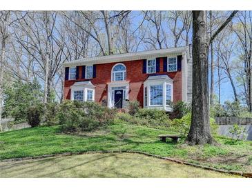 Charming two-story brick home with bay windows and mature trees in a desirable neighborhood at 910 Brentwood Ave, Lawrenceville, GA 30044