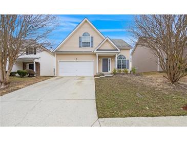 Charming home featuring a two-car garage, complemented by a well-maintained lawn and a welcoming entrance at 2760 Carolina Rdg, Riverdale, GA 30296