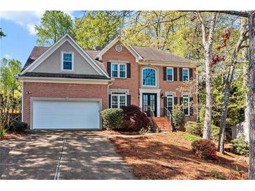 Beautiful two-story brick home with well-manicured landscaping and a two-car garage at 4103 Devon Wood Ne Dr, Marietta, GA 30066