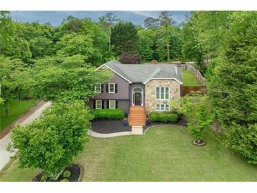 Charming two-story home with stone accents, landscaped lawn, and inviting entryway steps at 434 Shepard Sw Dr, Marietta, GA 30064