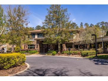 The property features a brick facade, well-maintained landscaping, and a charming entrance, exuding a welcoming atmosphere at 1800 Clairmont Lk # 221, Decatur, GA 30033