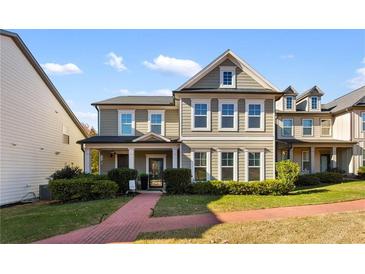 Charming two-story home featuring a landscaped yard and inviting entrance at 3673 Madison St, Atlanta, GA 30337