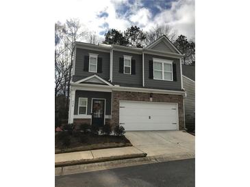 Charming two-story home features a brick facade, two-car garage and well-maintained landscaping at 230 Hickory Commons Way, Canton, GA 30115