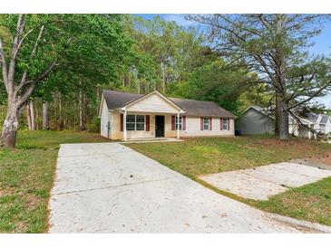 Charming single-story home featuring a well-manicured lawn and long concrete driveway at 700 Thomasville Se Blvd, Atlanta, GA 30315