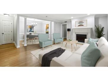 Bright living room with fireplace, plush seating, and open access to the dining area at 4430 Tilly Mill Rd # 1304, Atlanta, GA 30360