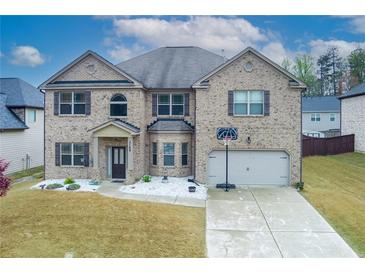 Beautiful two-story brick home featuring a well-maintained yard and attached two car garage at 3169 Shadystone Way, Loganville, GA 30052