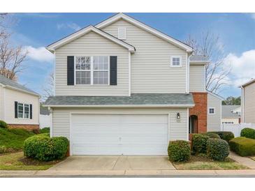 Charming two-story home with a white garage door and well-manicured landscaping at 102 Manley Ct, Woodstock, GA 30188