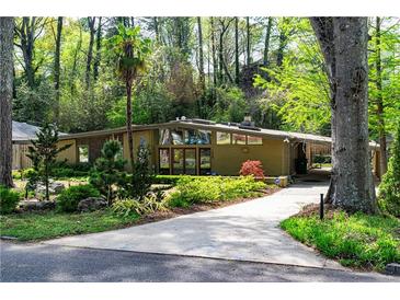 Contemporary home features a beautiful front yard with mature trees and unique architectural elements at 1428 Brook Valley Ne Ln, Atlanta, GA 30324