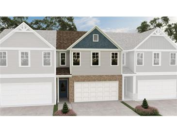 New townhome featuring a brick facade, attached garage, and a landscaped entrance at 6367 Towhee Way, Morrow, GA 30260