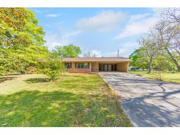 Charming single-story home featuring a spacious front yard and convenient covered parking at 1955 Starr Sw Rd, Conyers, GA 30094