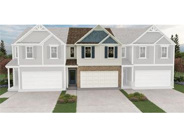 New construction townhome with charming exterior, a two-car garage, and a brick facade at 6350 Towhee Way, Morrow, GA 30260