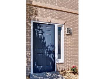 Stylish navy blue front door framed with brick and white trim, adding curb appeal to the home at 4095 Stillwater Dr, Duluth, GA 30096