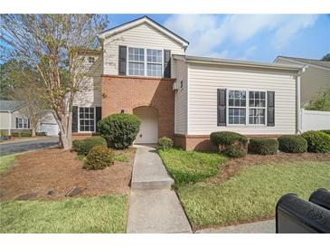 Charming two-story townhome with landscaped front yard and neutral siding at 612 Windcroft Nw Cir, Acworth, GA 30101