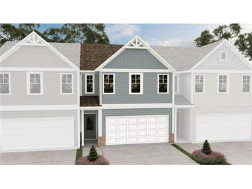 New construction townhome featuring blue siding, white trim, and a one-car garage at 6352 Towhee Way, Morrow, GA 30260