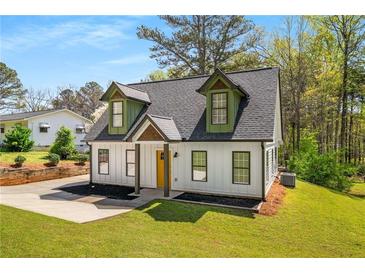 Charming home featuring eye-catching dormers, a new roof, and a bright yellow front door at 1071 N Price Rd, Sugar Hill, GA 30518