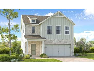 Charming two-story home with a mix of brick and siding, attached two car garage, and inviting front porch at 1375 Windance Lake Dr, Loganville, GA 30052