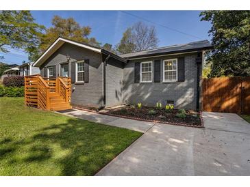 Charming home with painted brick, dark shutters, and a new wooden porch at 2189 Gordon Se Cir, Smyrna, GA 30080