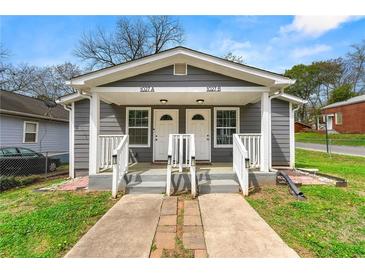 Charming duplex featuring dual entrances and a well-maintained front yard at 1027 Garibaldi Sw St, Atlanta, GA 30310