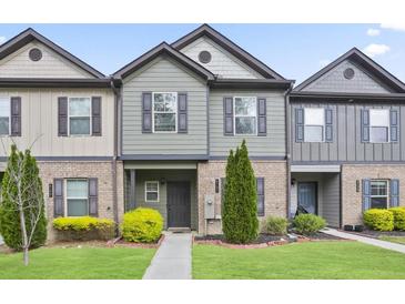 Charming townhome featuring a beautifully landscaped front yard and welcoming entryway at 4133 Shoals Ln, Union City, GA 30291