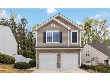 Charming two-story home featuring a stone-accented garage and well-manicured landscaping at 261 Silver Ridge Dr, Dallas, GA 30157