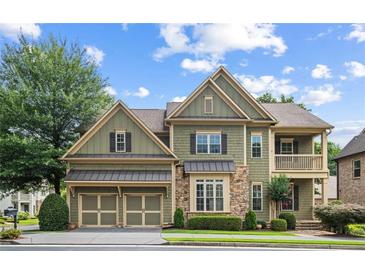 Inviting two-story home with a covered porch and manicured lawn, offering classic charm and curb appeal at 325 Valley Brook Way, Atlanta, GA 30342