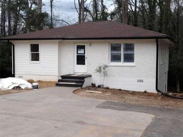 Charming one-story home with white painted brick and siding, updated roof, and inviting entrance at 3543 S Cobb S Dr, Smyrna, GA 30080