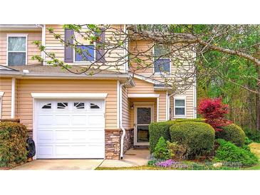 Charming townhome with a one-car garage and nicely landscaped front yard at 537 Rendezvous Rd, Acworth, GA 30102