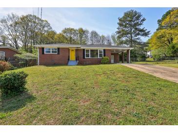 Charming single-story brick home featuring a bright yellow front door and a well-maintained front yard at 2519 Miriam Ln, Decatur, GA 30032
