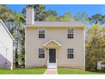 Charming two-story home with a cozy front porch and well-maintained lawn at 5228 Kirk Dr, Atlanta, GA 30349
