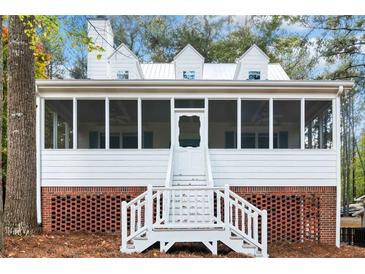 Inviting screened porch with steps leading to a brick base and white walls and roof at 5500 Mccoy Nw Rd # 15, Acworth, GA 30101
