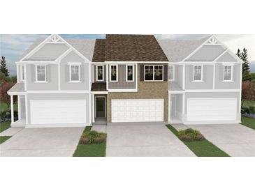 New two-story townhome featuring a brick facade, attached two-car garage, and manicured landscaping at 6354 Towhee Way, Morrow, GA 30260