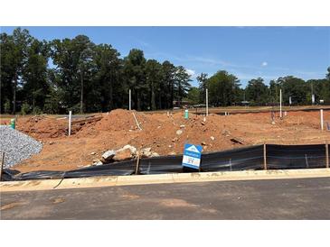 Available land lot featuring utility hookups ready for new construction in a treed community at 6354 Towhee Way, Morrow, GA 30260