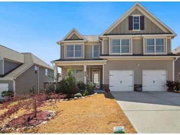 Inviting two-story home with manicured lawn and classic architectural details at 7937 Habanera Ln, Lithonia, GA 30058