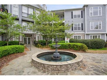Elegant condo community with a central water fountain and manicured landscaping at 4100 Paces Se Walk # 2309, Atlanta, GA 30339