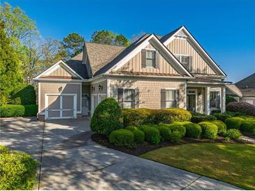 Charming home featuring a manicured front yard, classic shutters and a two-car garage at 6186 Talmadge Nw Run, Acworth, GA 30101
