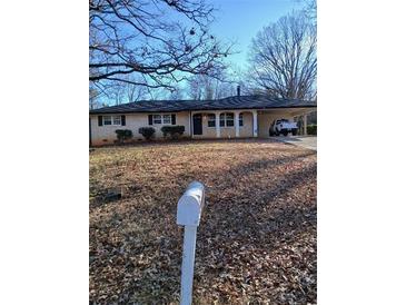 Charming single-story home featuring a covered parking area and a well-maintained front yard at 4985 Doby Ln, Austell, GA 30106