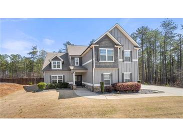 Charming two-story home featuring a landscaped yard and a welcoming front porch at 7500 Gillespie Pl, Douglasville, GA 30135