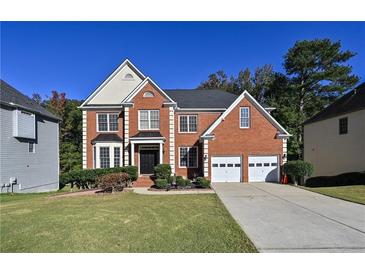 Charming brick two-story home with well-manicured lawn and a two-car garage on a sunny day at 1721 Telfair Chase Way, Lawrenceville, GA 30043
