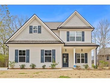 Charming two-story home with a welcoming front porch and classic architectural details at 1408 Seals Rd, Dallas, GA 30157