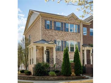 Charming brick townhome with manicured landscaping, dark shutters, and covered entry at 1962 Bainbridge Ln, Atlanta, GA 30345