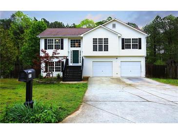 Charming two-story home with a well-maintained lawn, a two-car garage and a welcoming front porch at 301 Thorn Thicket Dr, Rockmart, GA 30153