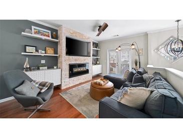 Comfortable living room with fireplace, TV, hardwood floor, stylish furniture and decor at 1741 Liberty Nw Pkwy, Atlanta, GA 30318