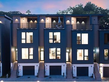 Modern townhome exterior featuring private balconies, attached garages, and stylish architectural details at 1570 Flat Shoals Se Rd # 4, Atlanta, GA 30316