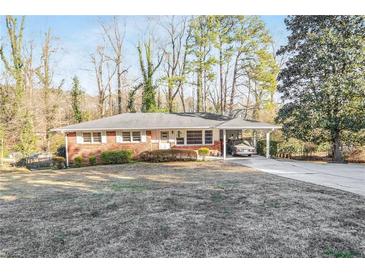 Charming brick home featuring a covered carport and a well-maintained front yard at 3073 Henderson Mill Rd, Atlanta, GA 30341