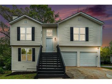 Charming two-story home with a welcoming front porch and two-car garage at 4490 Thornwood Trl, Stone Mountain, GA 30083