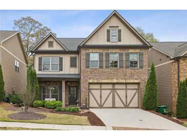 Charming two-story home featuring a brick facade and a two-car garage at 1895 Weston Ln, Tucker, GA 30084
