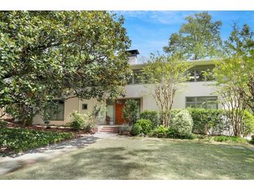 Charming home featuring mature trees, manicured landscaping, and a welcoming front entrance at 1211 Oakdale Ne Rd, Atlanta, GA 30307