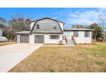 Charming two-story home featuring a brick facade, two-car garage, and a welcoming blue front door at 3862 Northstrand Dr, Decatur, GA 30035